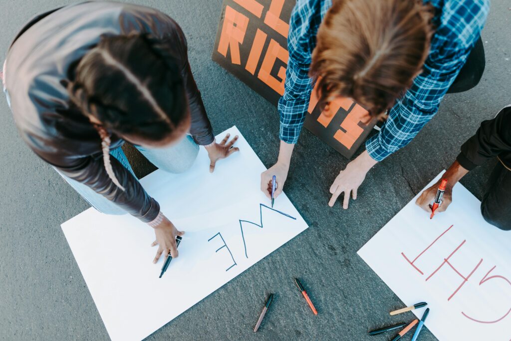 A People Writing on a Poster